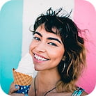 Smiling girl, with a big ice cream in a waffle cone