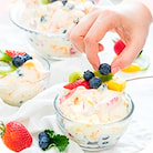 Three glass bowls with ice cream and berries