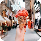 Red ice cream in a waffle cone with sprinkles