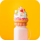 Milkshake with donut and whipped cream topping with berries